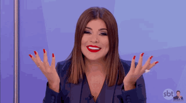 a woman with red nails and a sbt logo