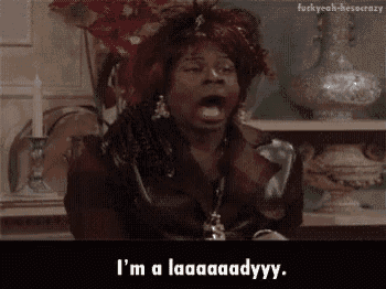 a woman is sitting at a table with her mouth open and saying `` i 'm a laaaadyy . ''