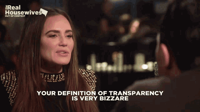 a woman says your definition of transparency is very bizarre in front of a bottle