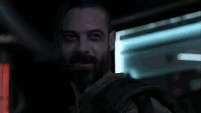 a man with a beard is looking at the camera