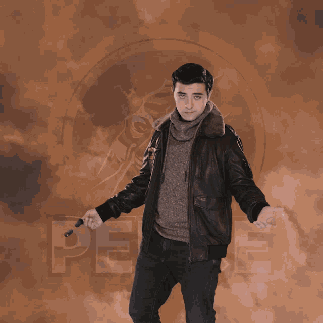 a man in a leather jacket holds a pair of sunglasses in front of a sign that says peace