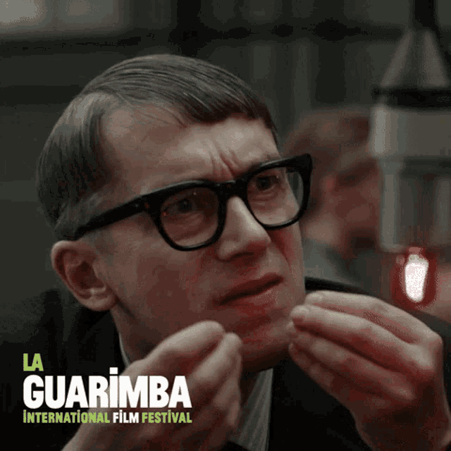 a poster for la guarimba international film festival shows a man with glasses