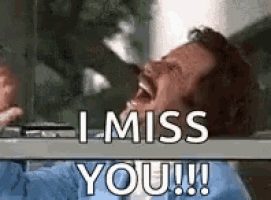 a man is laughing and saying `` i miss you '' while looking out a window .