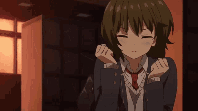 a girl in a school uniform with a red tie is making a funny face