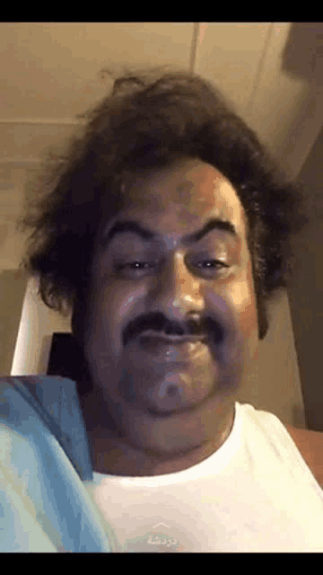 a man with a mustache and a wig is making a funny face .