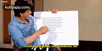 a man in a blue shirt is holding a sign that says google