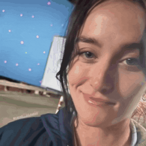 a close up of a woman 's face with a blue background and the words sarah_alfredo on the bottom right