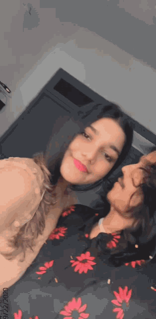 a man and a woman are posing for a picture and the woman is wearing red lipstick