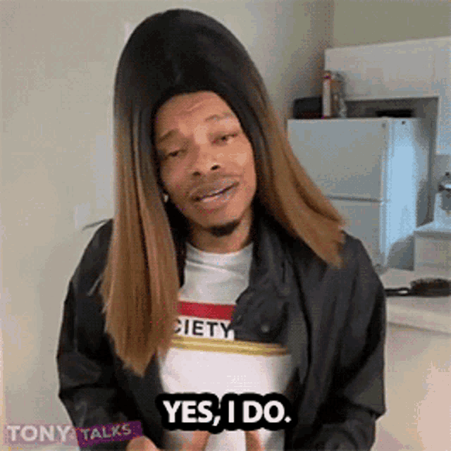 a man in a wig says yes i do in a kitchen