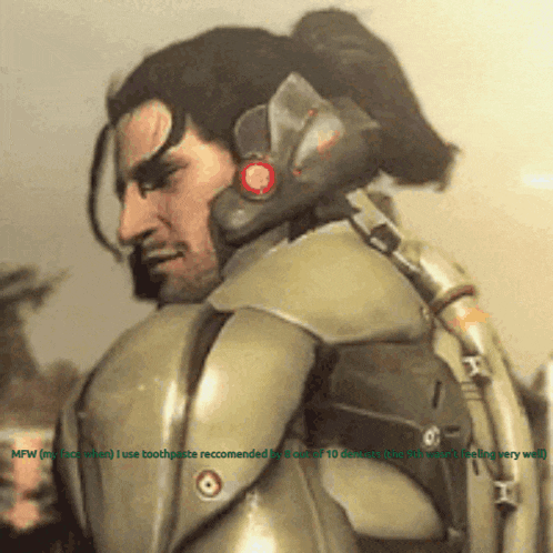 a man with a ponytail is wearing a green armored suit with a red button on the ear
