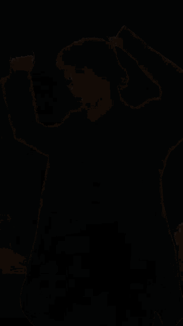 a person standing in a field with their arms outstretched