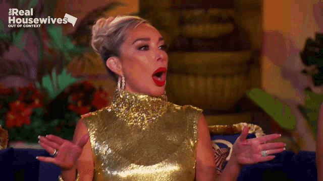 a woman in a gold sequined dress is on the real housewives television show