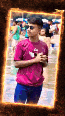 a young man in a pink shirt with an eagle on it stands in front of a crowd
