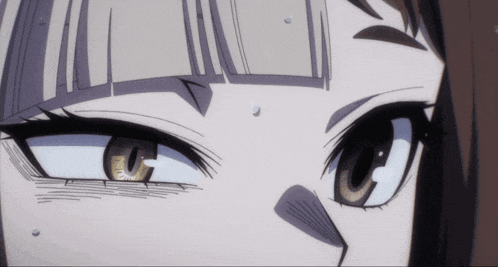 a close up of a girl 's eyes with a slight smirk