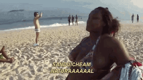 a woman on a beach with the words sandwicheam naturaaaaal written on the bottom