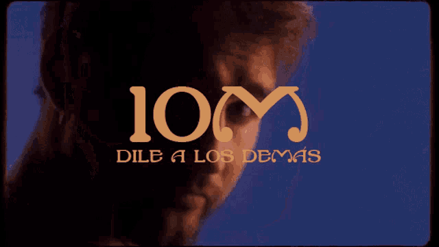 a close up of a man 's face with the letters 10m visible