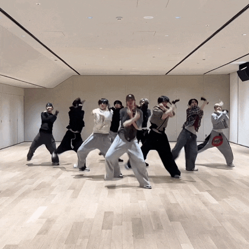 a group of people are dancing in a room and one of them has a bag that says ' coca cola ' on it