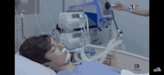 a man is laying in a hospital bed with the number 3 on the screen