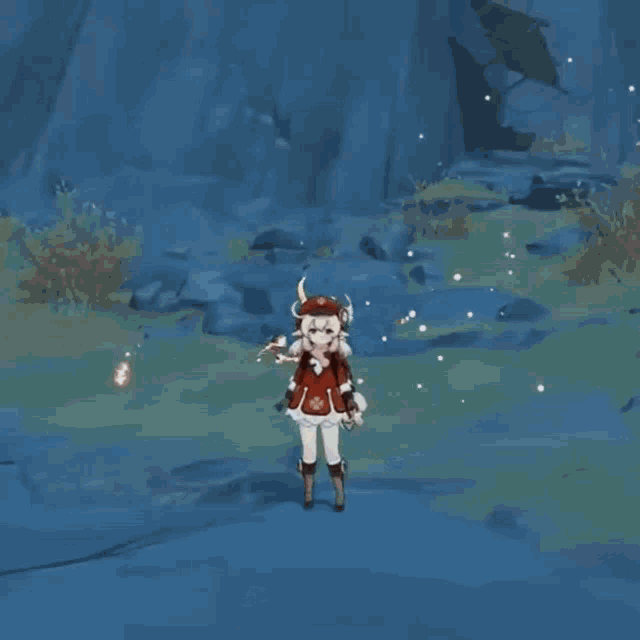 a girl in a red and white dress is standing in front of a mountain holding a cat .