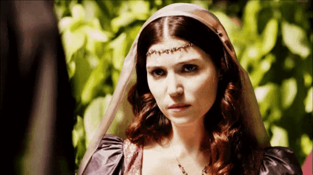 a woman wearing a veil and a purple dress