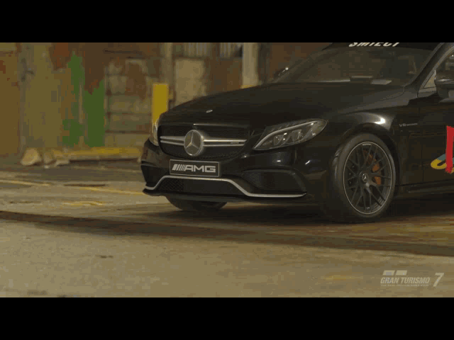a black amg car is parked in a garage