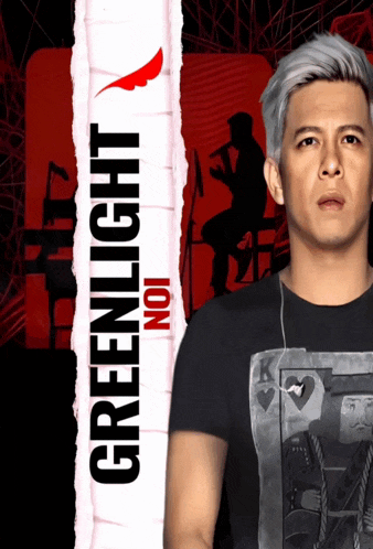 a man is standing in front of a greenlight noi sign