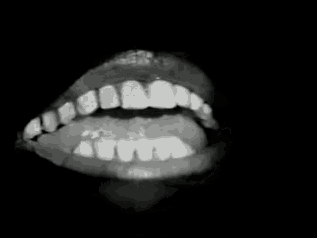 a close up of a person 's mouth with their tongue hanging out .
