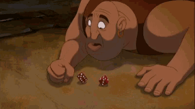 a man with a beard is laying on the ground with two dice in front of him .