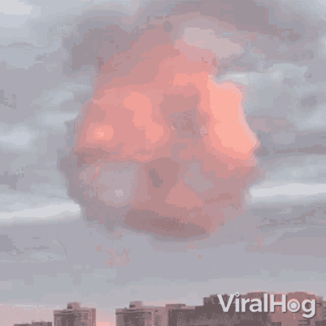 a pink cloud in a cloudy sky with viralhog written below it