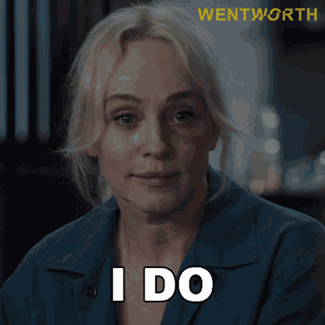 a woman in a blue shirt says " i do " in white letters