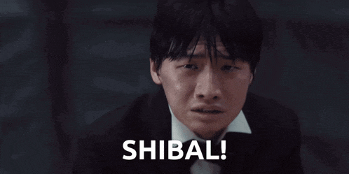a man in a tuxedo and bow tie is crying and the word shibal is next to him
