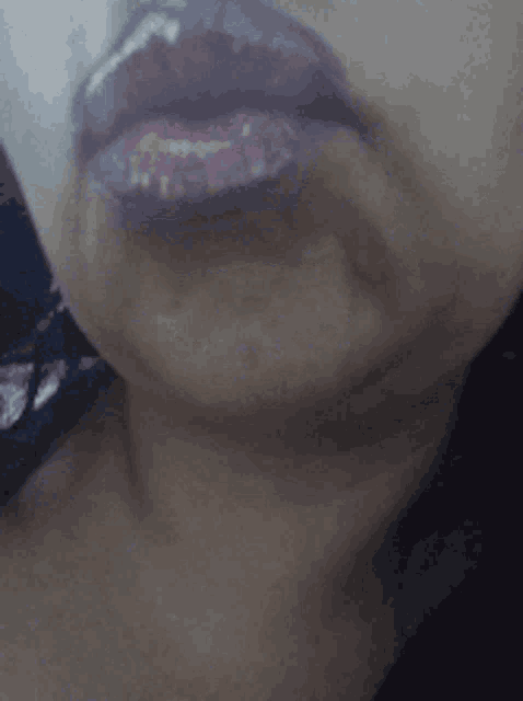 a close up of a woman 's mouth with purple lips