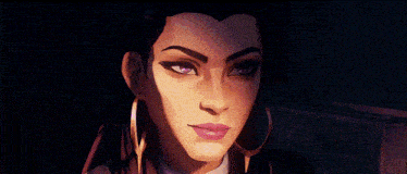 a close up of a woman 's face with purple eyes and gold hoop earrings
