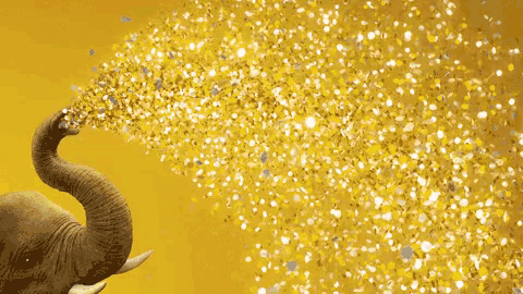 an elephant 's trunk is blowing gold confetti on a yellow background