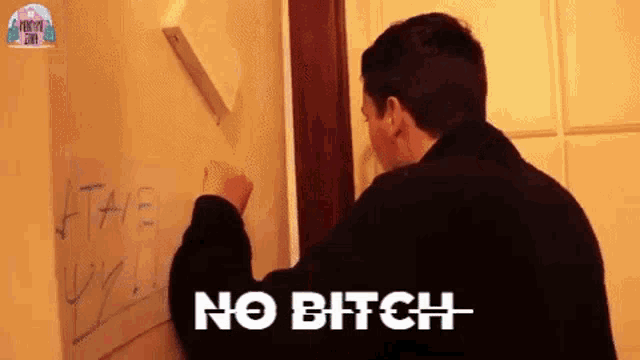 a man is writing on a white board that says no bitch