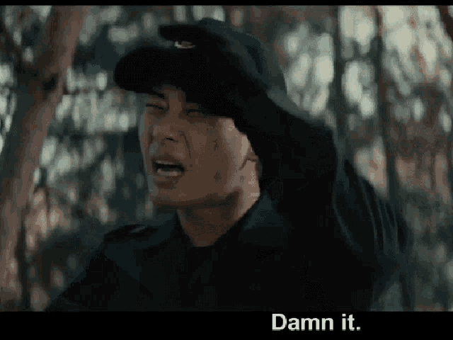 a man wearing a hat and gloves is crying with the words damn it below him