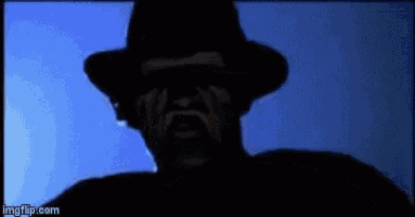 a silhouette of a man wearing a hat and sunglasses is looking at the camera .