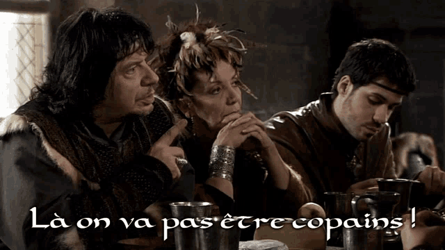 a group of people sitting around a table with the words la on va pas etre copains