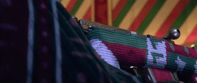 a close up of a purse with a red green and white pattern on it