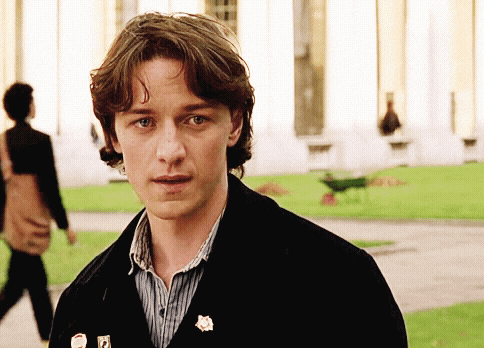 a man wearing a black jacket has a pin on his jacket that says ' a '