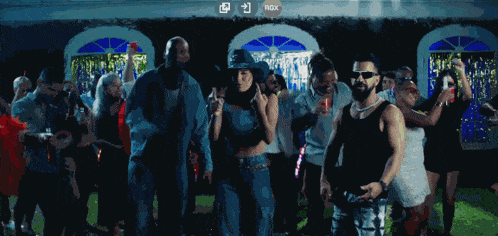 a group of people are dancing with the letters rdx above them