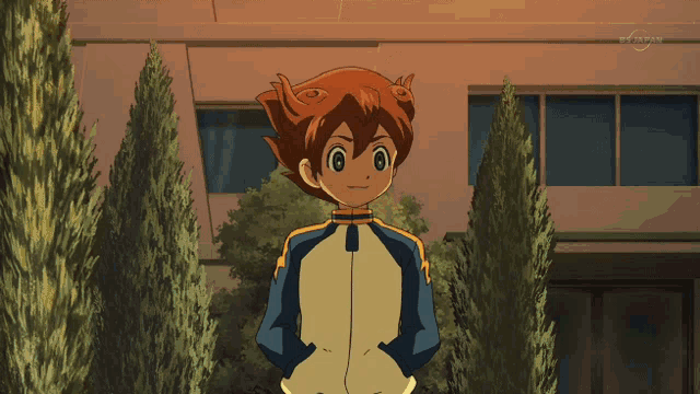 a boy and a girl are standing next to each other in front of a building that says tv tokyo on it