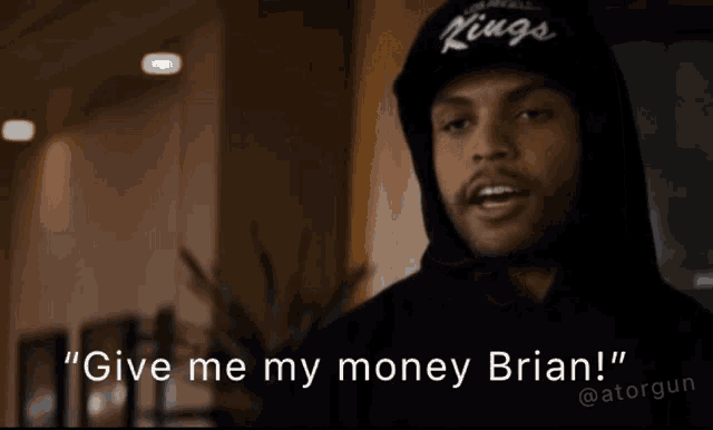 a man in a kings hat says " give me my money brian ! "