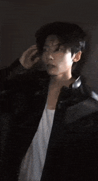 a close up of a man 's face in a dark room .