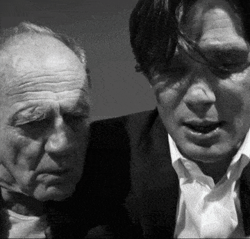 a black and white photo of two men in suits and ties
