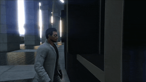 a man in a white coat and sunglasses is walking in a dark hallway