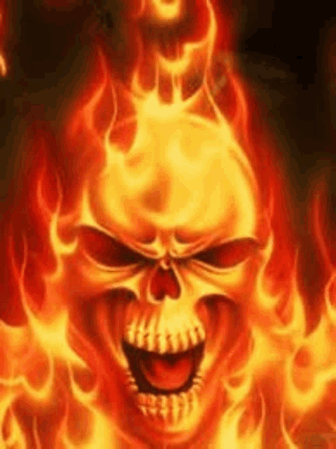 a skull is surrounded by flames and is laughing .