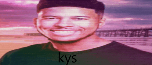 a man in a black shirt is smiling and the word kys is on the bottom