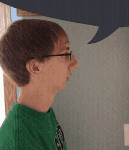 a young man wearing glasses and a green shirt that says ao