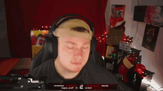 a man wearing headphones with the word rogue on the screen behind him